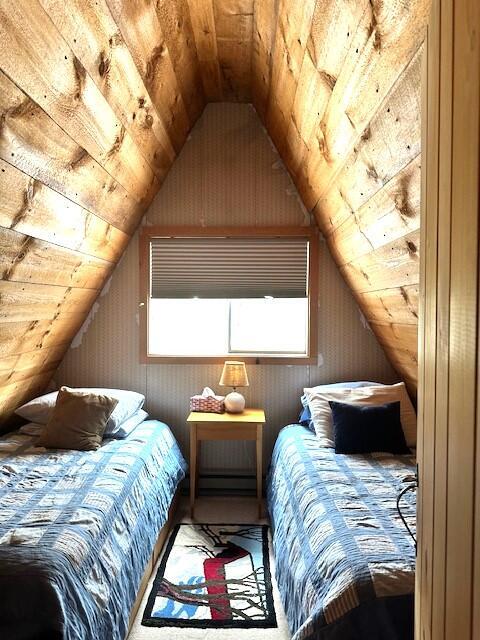 unfurnished bedroom featuring vaulted ceiling and wooden ceiling