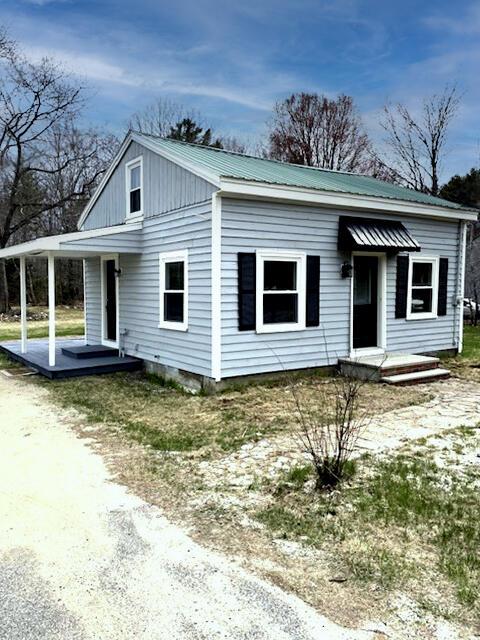 bungalow-style house with covered porch and metal roof
