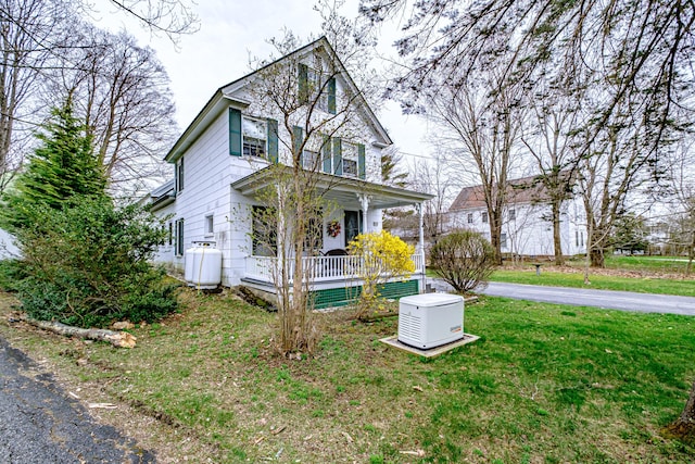 view of front of house with a front yard and a porch