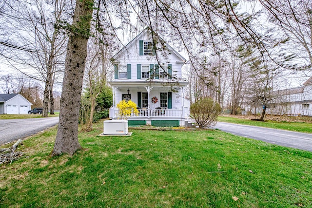 view of front of property with a front yard, a porch, and aphalt driveway