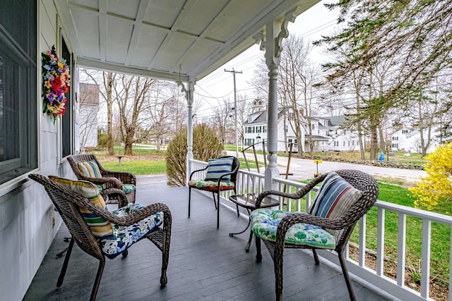 wooden terrace featuring a porch and a residential view