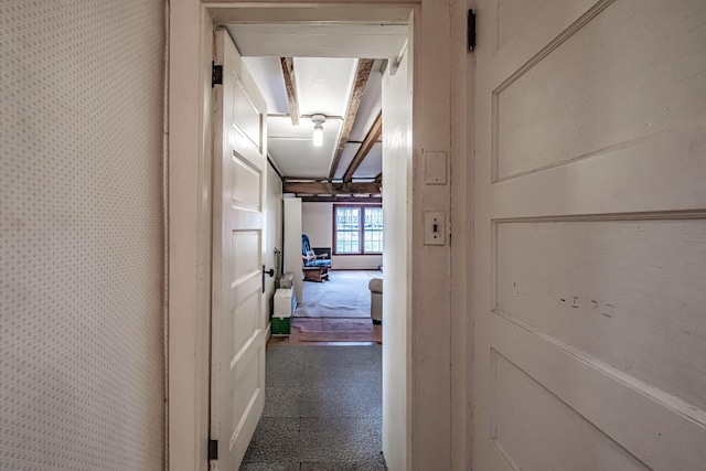 hall featuring wallpapered walls