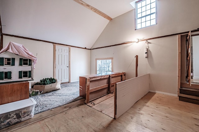 interior space with baseboards and high vaulted ceiling