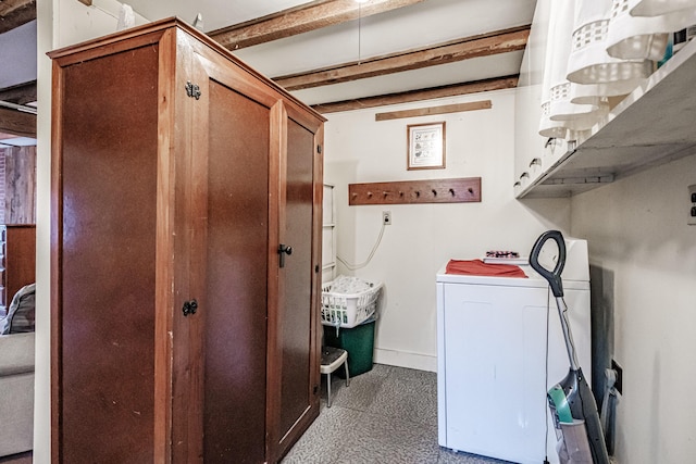 laundry area featuring baseboards, cabinet space, and washer / dryer