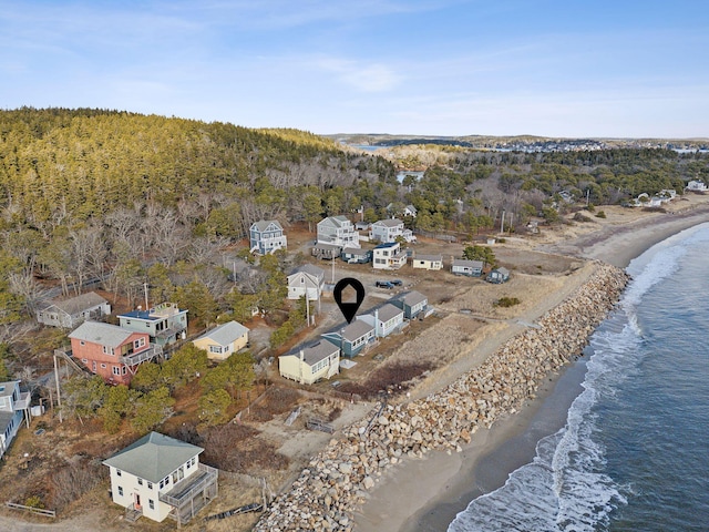 aerial view with a view of the beach, a view of trees, and a water view