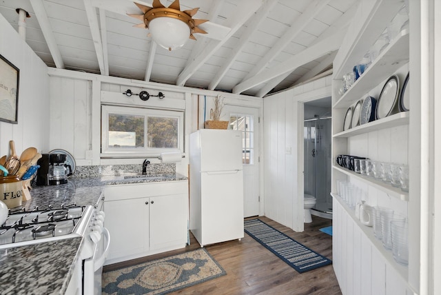 kitchen with dark wood-style flooring, a sink, white appliances, plenty of natural light, and vaulted ceiling with beams