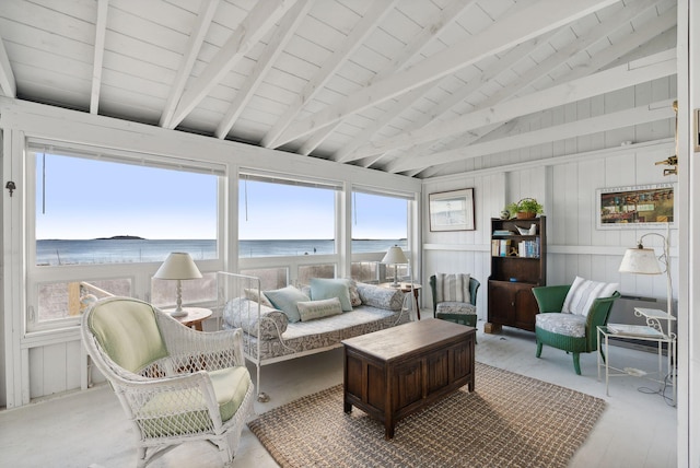 sunroom / solarium featuring a water view, beamed ceiling, and plenty of natural light