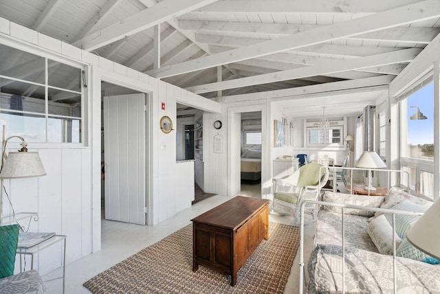 living room with vaulted ceiling with beams