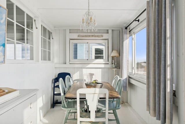 sunroom / solarium with a notable chandelier