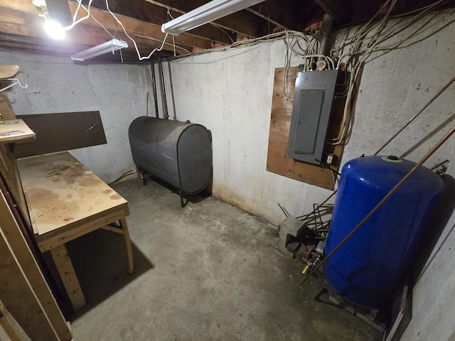 369 Hawes Bridge Rd, Prospect, ME 04981 - unfinished basement featuring oil tank, electric panel, and a water pressure tank