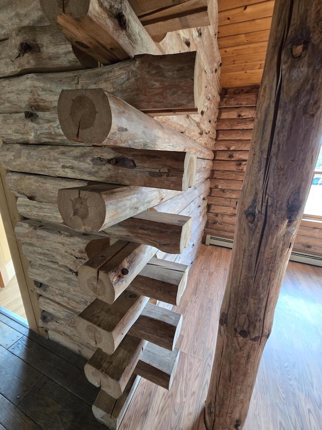 369 Hawes Bridge Rd, Prospect, ME 04981 - detailed view of rustic walls, wood finished floors, and a baseboard heating unit