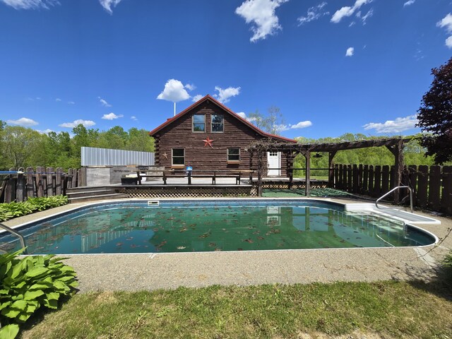 369 Hawes Bridge Rd, Prospect, ME 04981 - view of swimming pool with a wooden deck and a fenced backyard