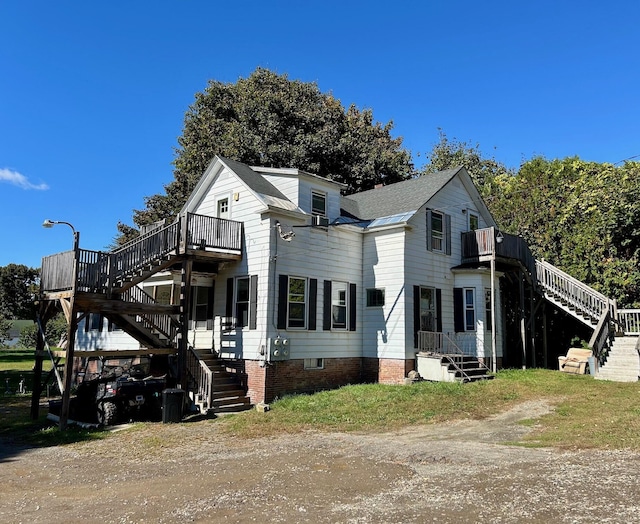 view of front of property with a deck and stairway