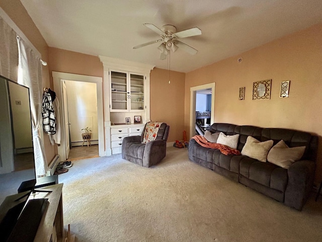 carpeted living area with a ceiling fan and baseboard heating