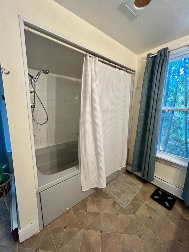 bathroom with tile patterned flooring and shower / bath combination with curtain