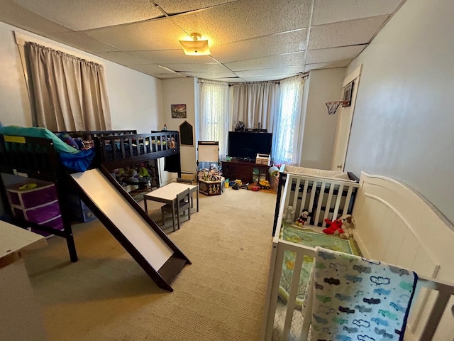 rec room with a drop ceiling and carpet floors