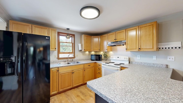 kitchen featuring black appliances, a sink, under cabinet range hood, and light countertops