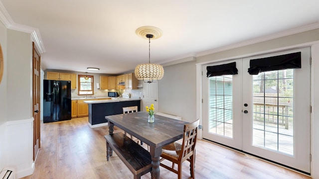 dining room featuring french doors, light wood-type flooring, a baseboard radiator, and crown molding