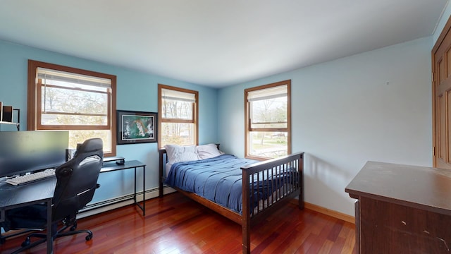 bedroom with wood-type flooring, multiple windows, baseboards, and a desk