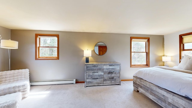carpeted bedroom featuring a baseboard radiator, multiple windows, and baseboards