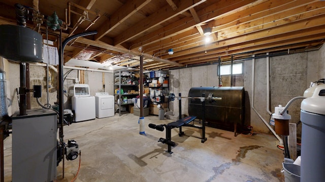 basement with heating fuel, washer and dryer, and a water softener system