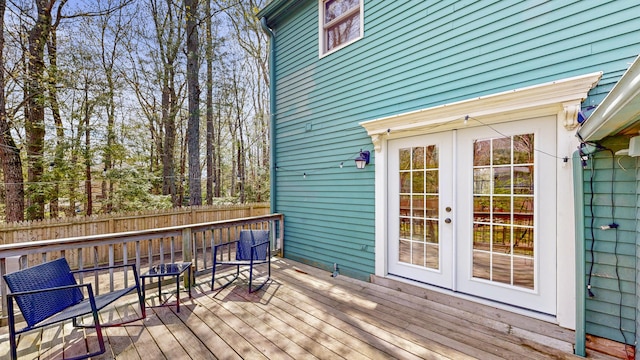wooden deck featuring french doors and fence