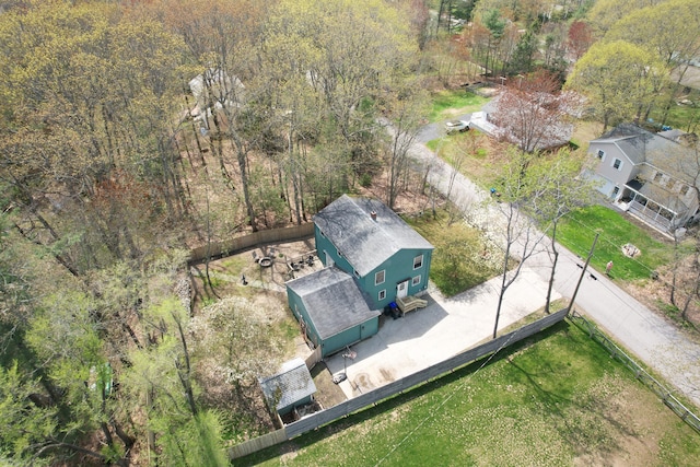aerial view of property and surrounding area featuring a forest
