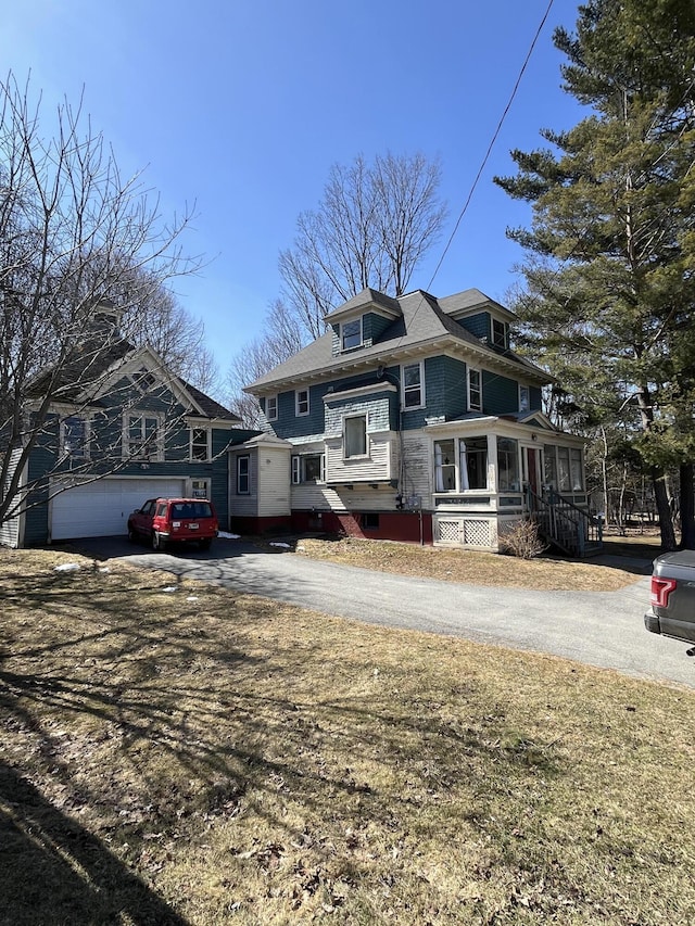 american foursquare style home with aphalt driveway