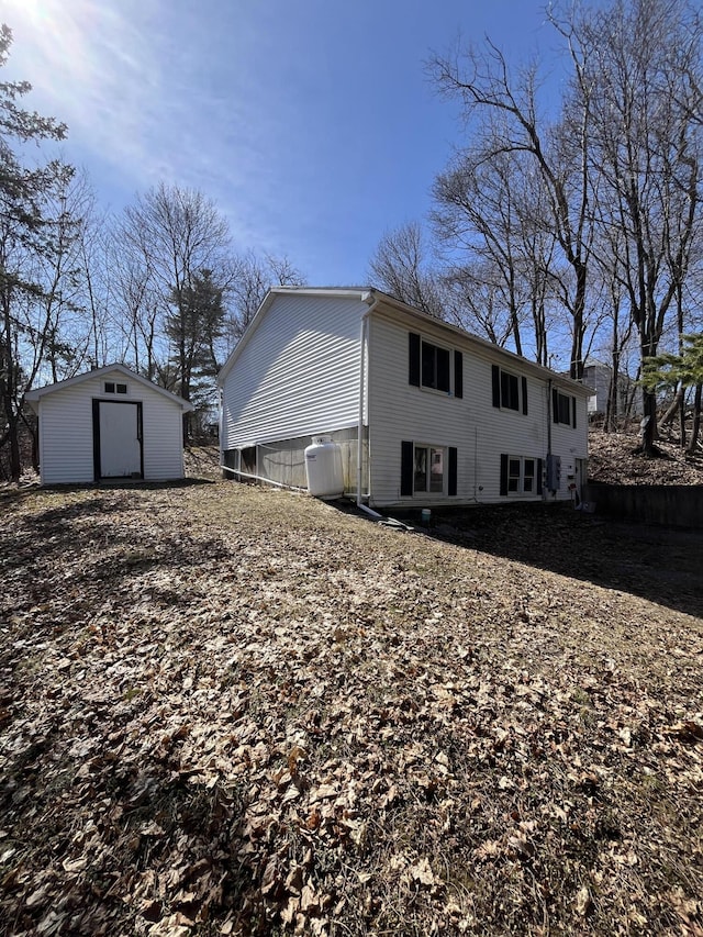 back of property featuring an outbuilding and a shed