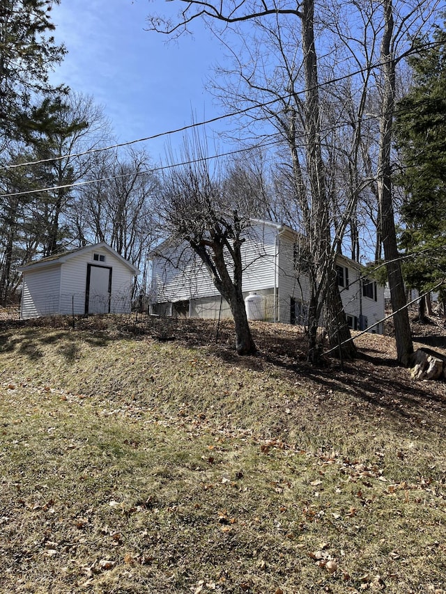 view of yard featuring fence and an outdoor structure