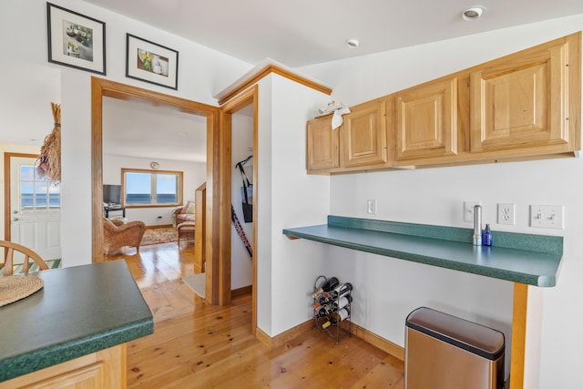 347 Webhannet Dr, Wells, ME 04090 - kitchen featuring light wood-style flooring, baseboards, light brown cabinetry, and dark countertops