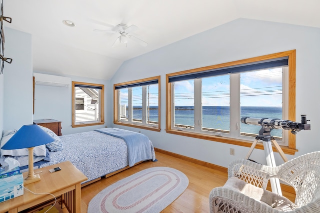 347 Webhannet Dr, Wells, ME 04090 - bedroom featuring a wall mounted AC, baseboards, lofted ceiling, a water view, and wood finished floors