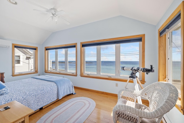 347 Webhannet Dr, Wells, ME 04090 - bedroom with baseboards, lofted ceiling, a ceiling fan, wood finished floors, and a wall unit AC