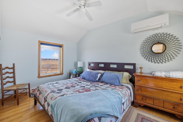 347 Webhannet Dr, Wells, ME 04090 - bedroom with a wall mounted air conditioner, light wood finished floors, vaulted ceiling, and ceiling fan