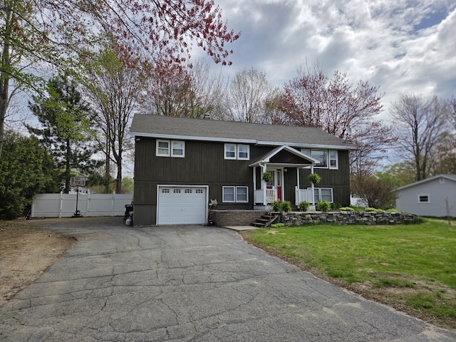 134 Minuteman Dr, Millinocket, ME 04462 - raised ranch featuring driveway, covered porch, and an attached garage