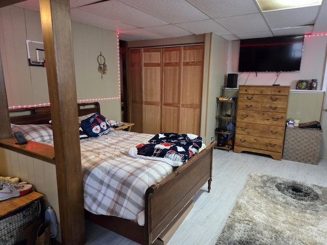 134 Minuteman Dr, Millinocket, ME 04462 - bedroom featuring wood finished floors, a closet, and wooden walls