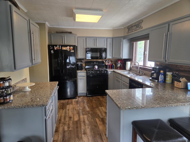 134 Minuteman Dr, Millinocket, ME 04462 - kitchen with black appliances, a sink, gray cabinetry, a peninsula, and light stone countertops