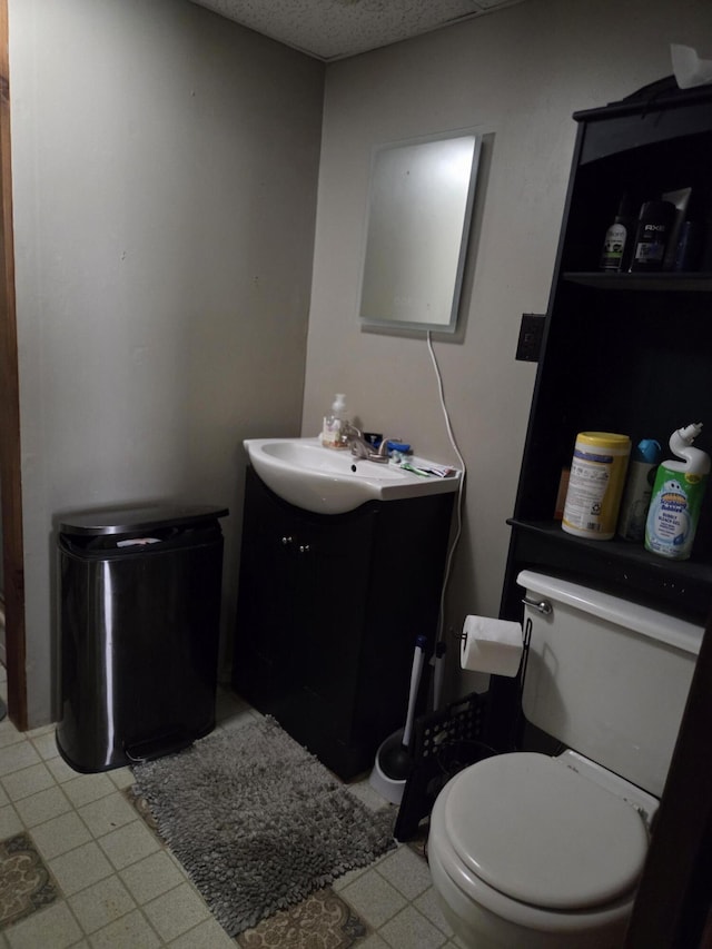 134 Minuteman Dr, Millinocket, ME 04462 - bathroom with toilet, vanity, and tile patterned floors