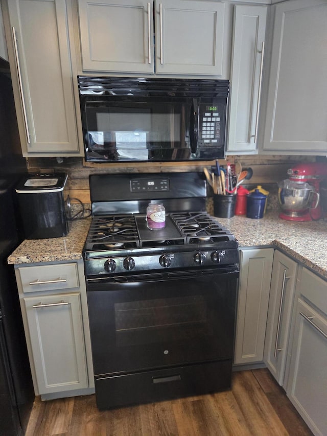 134 Minuteman Dr, Millinocket, ME 04462 - kitchen with black appliances, wood finished floors, light stone counters, and tasteful backsplash