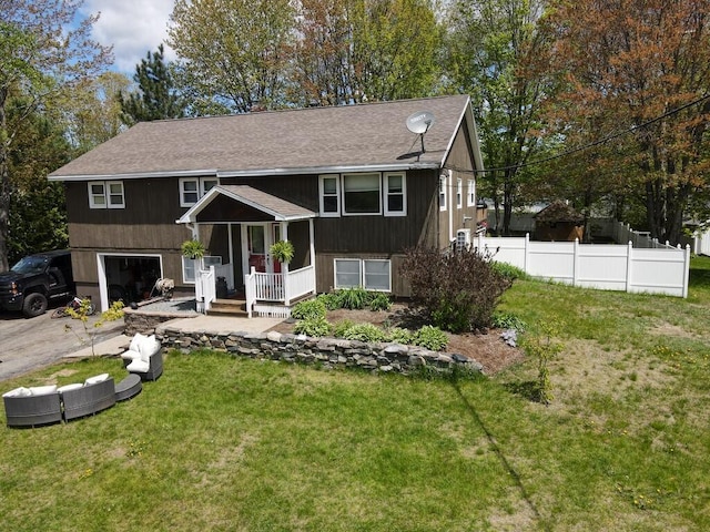 134 Minuteman Dr, Millinocket, ME 04462 - bi-level home with an attached garage, roof with shingles, concrete driveway, and covered porch