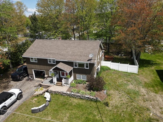 134 Minuteman Dr, Millinocket, ME 04462 - view of front of home with asphalt driveway, a shingled roof, covered porch, a garage, and view of scattered trees