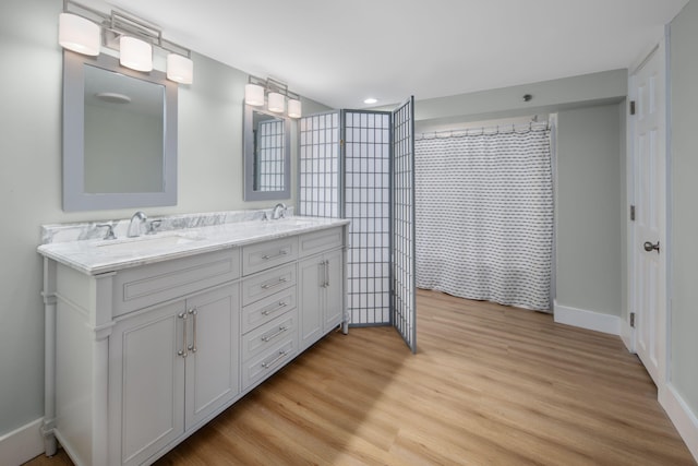 18 Trafton Ln, Kittery, ME 03904 - bathroom with double vanity, wood finished floors, baseboards, and recessed lighting
