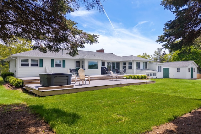 18 Trafton Ln, Kittery, ME 03904 - rear view of house featuring a wooden deck, a hot tub, a yard, a chimney, and an outbuilding