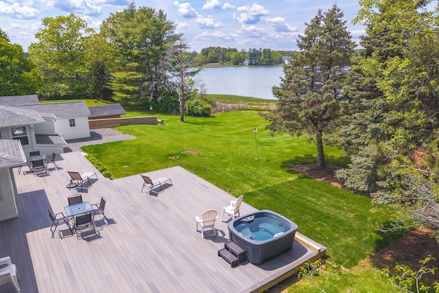 18 Trafton Ln, Kittery, ME 03904 - view of grassy yard featuring a deck with water view, outdoor dining area, a hot tub, and an outdoor structure