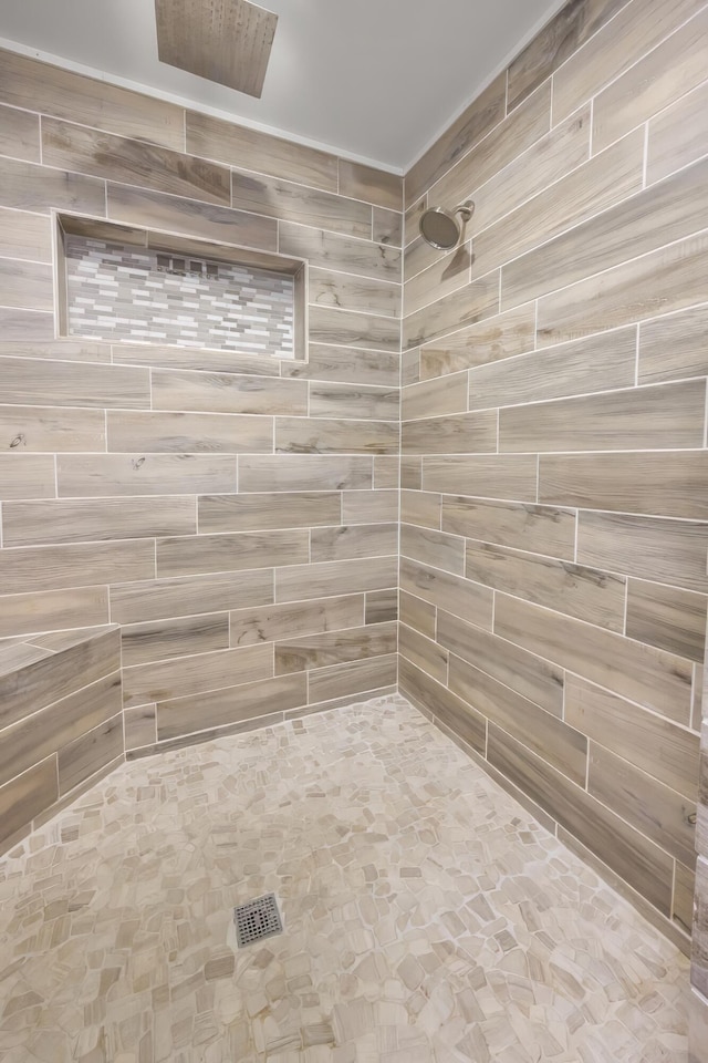 full bath featuring a tile shower