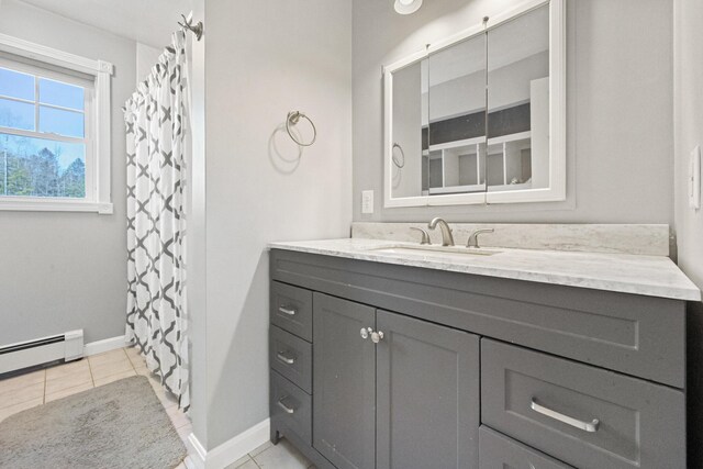573 Exeter Rd, Corinth, ME 04427 - full bathroom featuring baseboard heating, vanity, tile patterned flooring, and baseboards