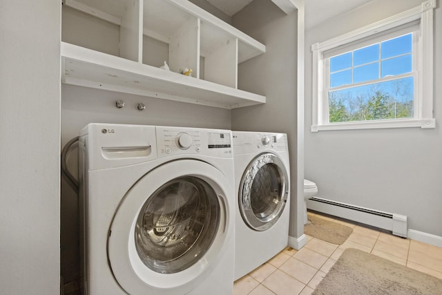573 Exeter Rd, Corinth, ME 04427 - laundry room with a baseboard heating unit, washing machine and dryer, light tile patterned floors, and baseboards