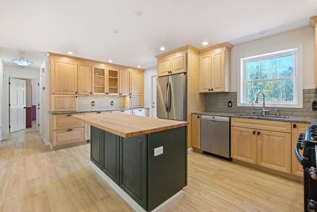 573 Exeter Rd, Corinth, ME 04427 - kitchen featuring appliances with stainless steel finishes, light brown cabinetry, a sink, wood counters, and decorative backsplash