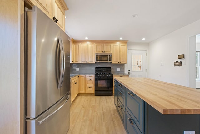 573 Exeter Rd, Corinth, ME 04427 - kitchen featuring stainless steel appliances, light brown cabinetry, wood counters, light wood-style floors, and tasteful backsplash
