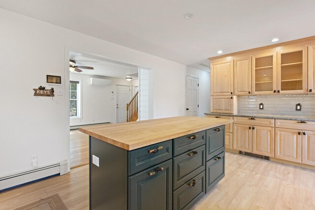 573 Exeter Rd, Corinth, ME 04427 - kitchen featuring a baseboard heating unit, light brown cabinetry, a wall mounted air conditioner, light wood-style floors, and recessed lighting